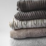 sweaters organized neatly, winter capsule wardrobe 2020