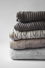 sweaters organized neatly, winter capsule wardrobe 2020