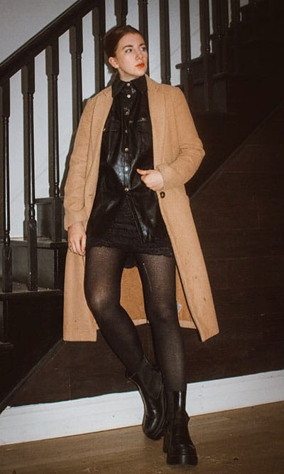 winter capsule wardrobe example on style blogger gabrielle arruda. wearing a camel coat, leather shirt, combat boots, and tights