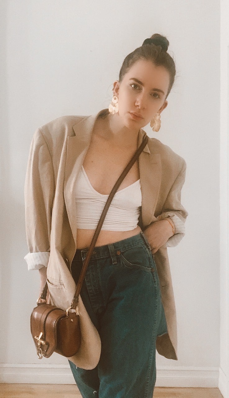 hailey bieber outfit inspired with jeans blazer and cropped tank and top knot