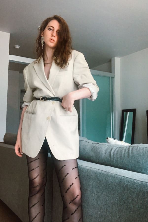 style blogger gabrielle arruda waering the fashion style "nyc style" - belted tan blazer as dress with balenciaga logo tights and a pair of statement earrings. types of fashion styles with pictures