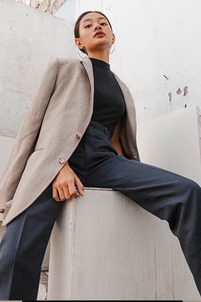 example of types of fashion style: business casual. girl in blazer, turtleneck, and loose wide leg trousers