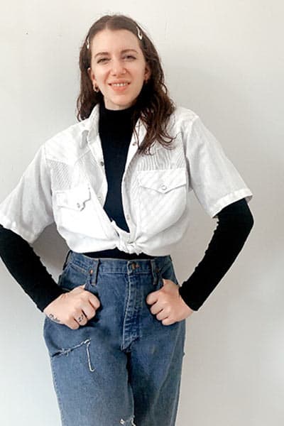 example of how to style a men's piece as a woman- gabrielle arruda wearing men's short sleeve shirt over turtleneck 