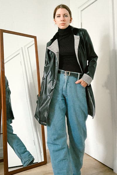 how to look polished, keep the whole look in mind, outfit on gabrielle arruda wearing straight leg jeans, turtleneck, with low bun and leather coat 