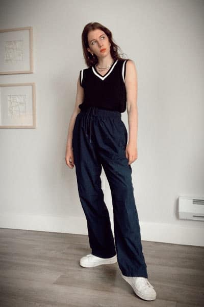 sweater vest aesthetic with athletic pants and classic white sneakers