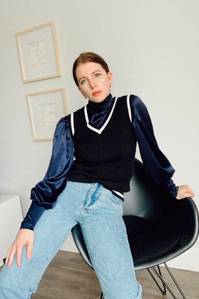 sweater vest outfit with blouse and straight leg jeans