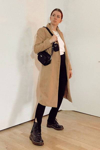 doc martens outfits winter with split ankle leggings and camel coat with nylon prada bag