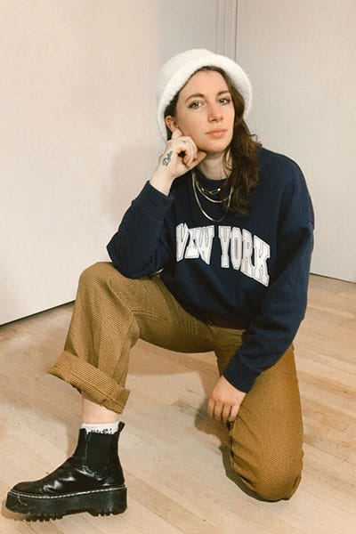 doc martens winter outfit ideas with trouser, oversized sweatshirt, and bucket hat