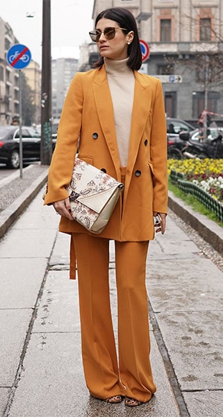 winter fashion trend colorful suit, amber/orange suit with turtleneck on fashion influencer