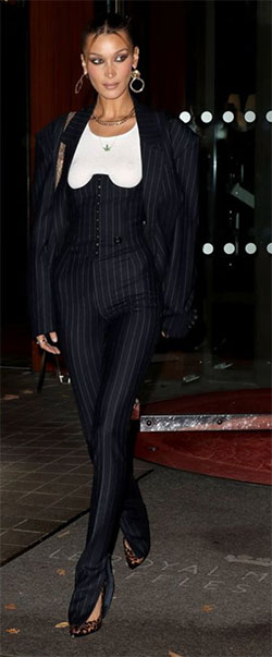 bella hadid style with black pinstripe suit and under corset with white tee under half corset