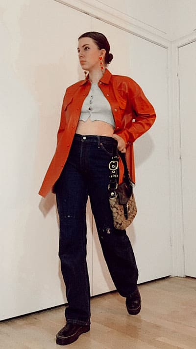 bella hadid style inspiration on gabrielle arruda. baggy jeans cropped cardigan and orange leather shirt over with doc martens