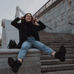 girl in turtleneck, blazer, jeans, and combat boots. example of doc martens alterantives combat boots