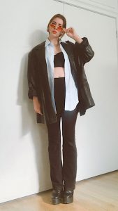 black flare leggings outfit with crop top, leather blazer and mens short sleeve shirt and retro 90's red mini sunglasses