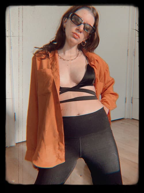 black flare leggings with bralette tie top and vintage blouse and rectangular sunglasses