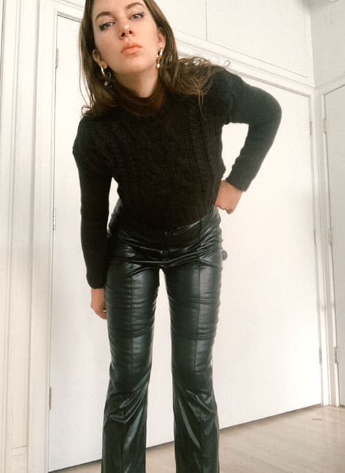 leather pants outfit ideas with sweater and structured shoulder turlteneck. gold hoops and simple makeup for workplace