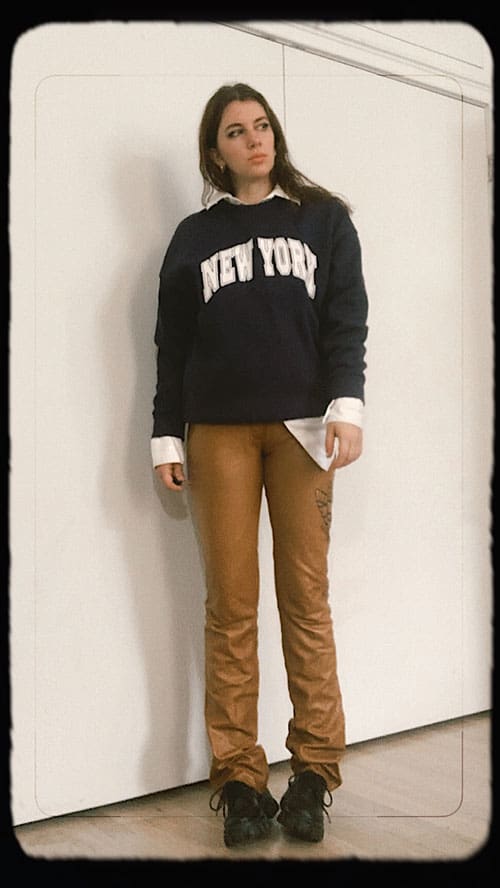 trendy leather pants outfit ideas with sweatshirt layered over mens collared shirt and doc loafers
