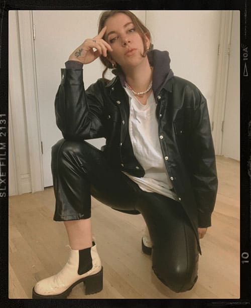 leather pants outfit ideas with shacket and white chunky boots. shacket layered over hoodie and oversized shirt on style blogger gabrielle arruda