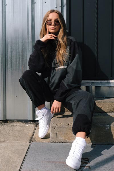 athleisure fashion style picture, girl with matching black sweatsuit and air force 1's and sunglasses