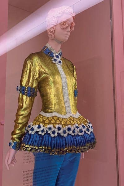 fashion styles: camp fashion. example from met gala exhibit gold jacket with puff sleeves and peplum
