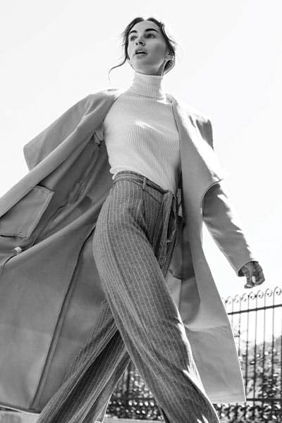elegant fashion style picture, woman in turtleneck, wide leg trousers and trench coat