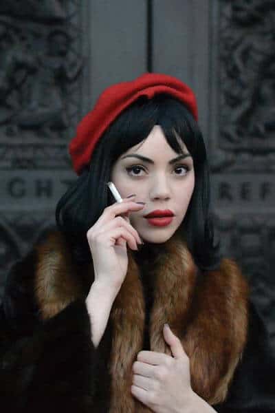 types of fashion styles, french fashion style, woman in a black coat with fur lining, red lipstick and red beret