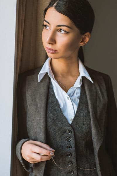 garconne fashion style, woman in men's 3 piece suit and blue collared shirt