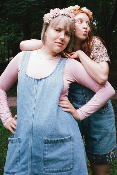 modern hippie fashion style, two girls in flower crowns, and denim dress over long sleeve shirt