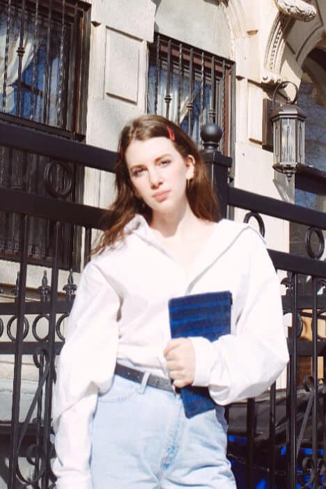 spring capsule wardrobe outfit idea using men's white shirt. men's white shirt on style blogger gabrielle arruda with mom jeans, blue celine clutch, flip clips in hair, and a black belt