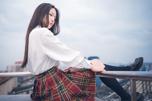 preppy fashion style, girl in white blouse, plaid skirt and knee high socks