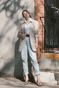  gabrielle arruda in linen blazer over men's white shirt tucked into mom jeans with strappy heels