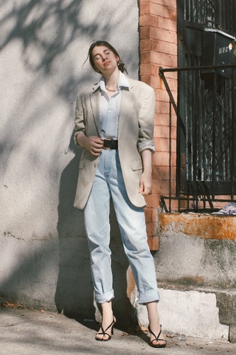 spring capsule wardrobe outfit on gabrielle arruda. linen blazer over men's white shirt tucked into mom jeans with strappy heels
