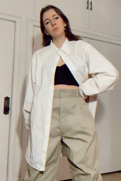 summer fashion trends, wide leg khakis. style blogger gabrielle arruda wearing men's white button up with black corset underneath and wide leg khakis