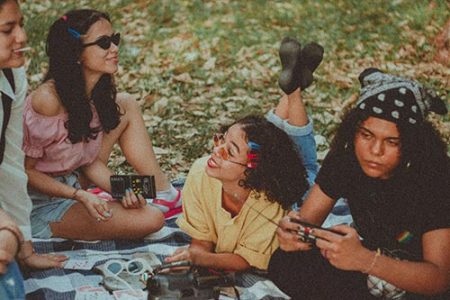 different types of fashion styles with pictures, a picture of several girls wearing vintage clothing. one girl has a graphic tee and flip clips, the other has a vintage blouse and 90's sunglasses and one has a bandana in her hair