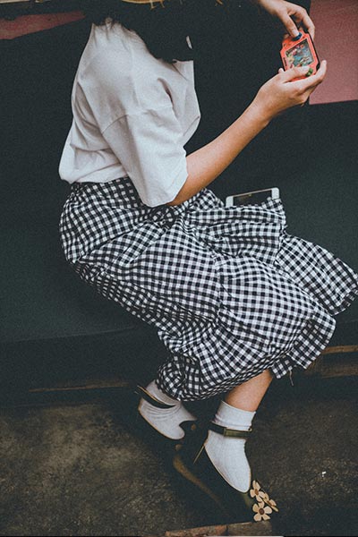 vintage fashion style, types of fashion styles with pictures, girl in white tee with vintage gingham skirt and mary jane docs with socks