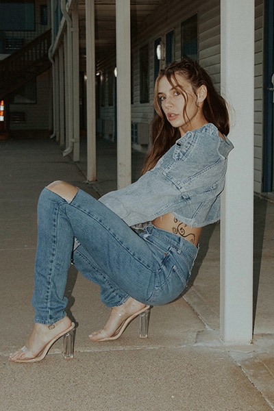 girl wearing medium wash jeans and light wash denim jacket, double denim outfit example with clear heels