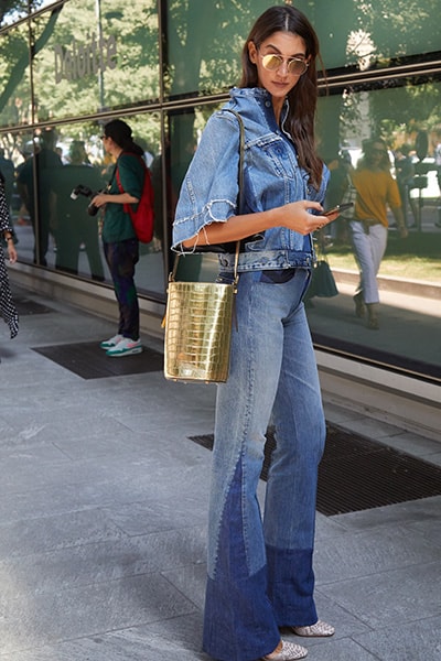 double denim outfit on style influencer. matching denim washes with cropped denim jacket and denim flares 