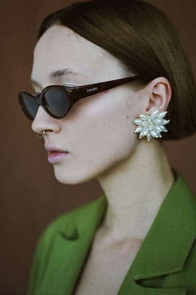 statement earrings and sunglasses on fashionable girl- how to improve your style by adding accessories