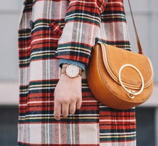 image of girl wearing plaid coat with purse and watch, how to get better style- add accessories and finish the outfit and look prettier