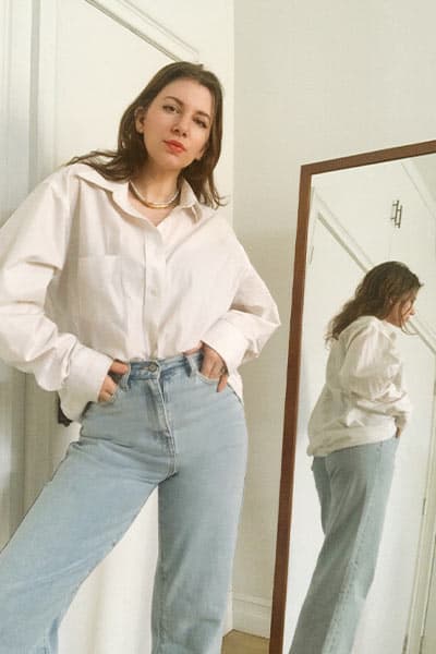 gabrielle arruda wearing straight leg lana jeans with men's classic button up french tucked for fall 