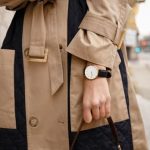 woman in trench coat with watch and black handbag, fashion details help express your personal fashion style