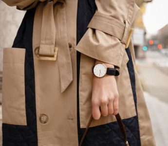 woman in trench coat with watch and black handbag, fashion details help express your personal fashion style