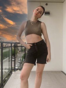 gabrielle arruda in summer capsule wardobe 2021 waffle crop top and agolde black long denim shorts