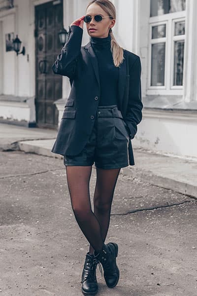 girl wearing shorts and blazer with turtleneck and suits