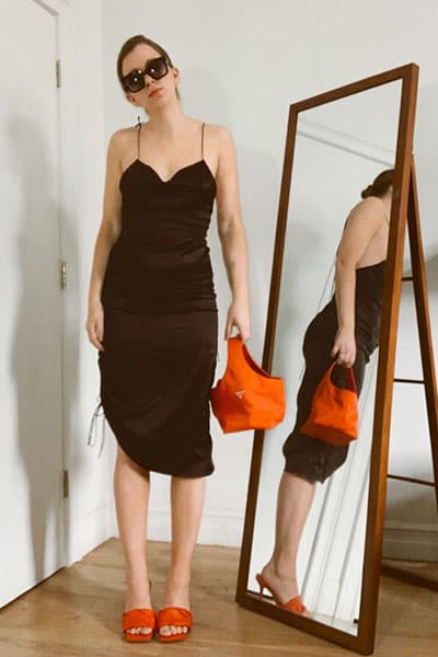 gabrielle arruda in a style inspired by Rosie Huntington whiteley outfit. Black midi skirt, bottega venetta mules, prada handbag and sunglasses 