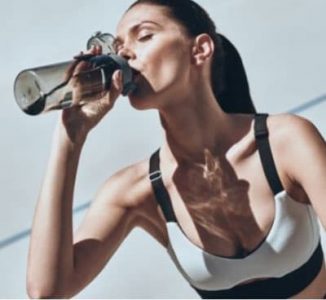 woman drinking water, hydration is an important part of looking pretty naturally