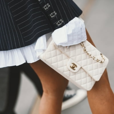 woman carrying cream chanel boy bag