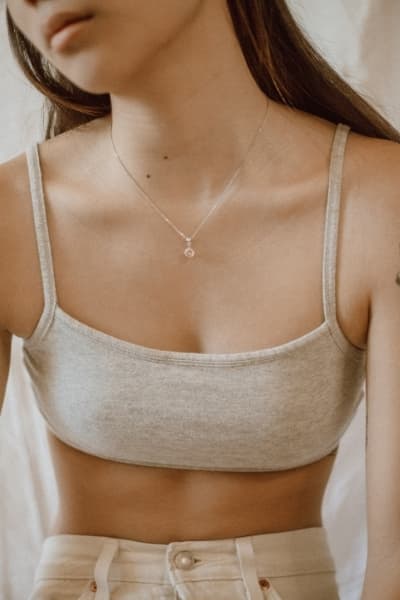woman in wool bralette with simple necklace