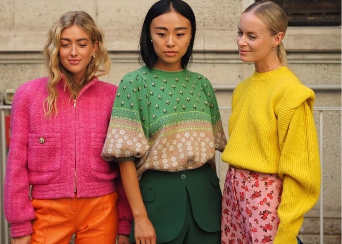 how to color block, three women all wearing color block outfits