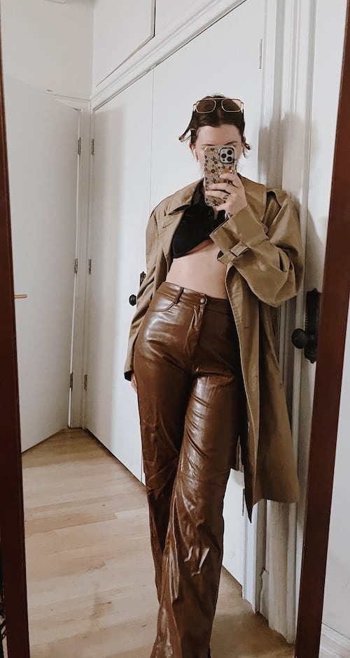 gabrielle arruda wearing thrifted trench coat to show style on a budget