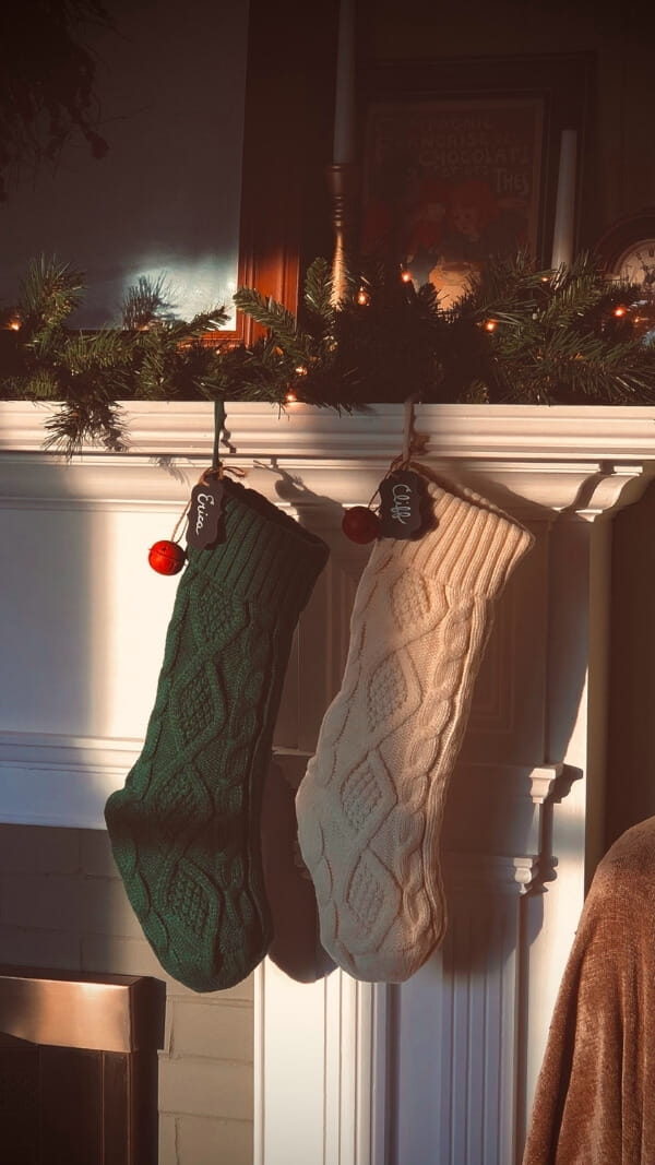 photo of Christmas stockings hanging on mantle at golden hour light - christmas wallpaper iphone